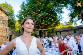 A documentary style photographer captures a raw, emotional moment at the Domaine de Montplaisir. The image shows the bride shedding tears of joy while listening to heartfelt speeches during the reception.